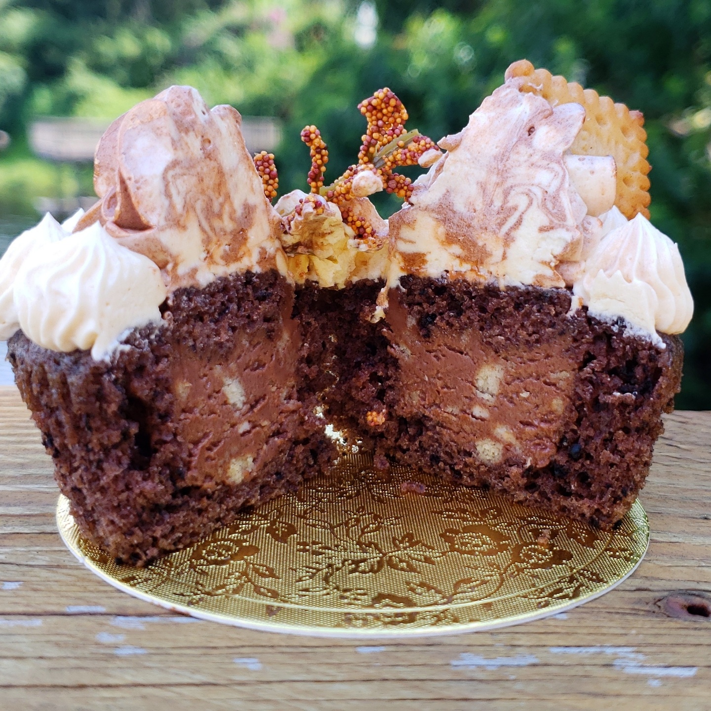 One chocolate cupcake cut in half, filled with chocolate filling